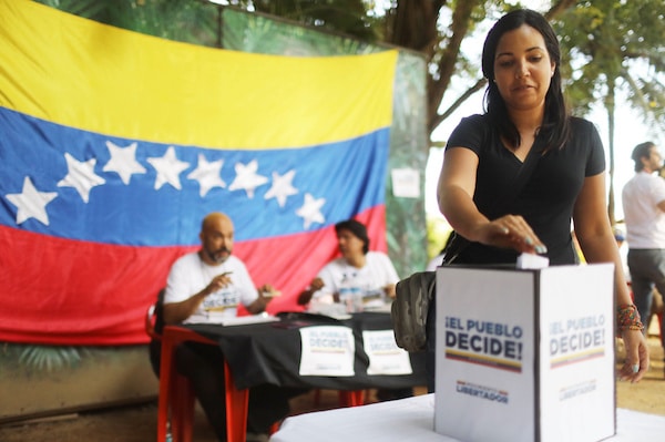 | RIO DE JANEIRO BRAZIL JULY 16 An expatriate Venezuelan casts her ballot during an unofficial referendum or plebiscite held by Venezuelas opposition against Venezuelas President Nicolas Maduros government on July 16 2017 in Rio de Janeiro Brazil Voting was conducted across 2000 polling centers in Venezuela and in more than 80 countries around the world amidst a severe crisis in Venezuela Photo by Mario TamaGetty Images | MR Online