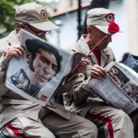 Members of the Bolivarian Militia read Ciudad Caracas newspaper, while waiting for the Constituent Assembly installation