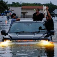 Residents Using Truck To Navigate Through Flood Water