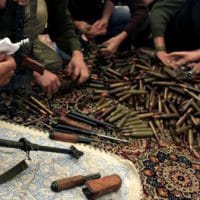 Free Syrian Army militants clean their weapons and check ammunition at their base on the outskirts of Aleppo, Syria. (Khalil Hamra/AP)