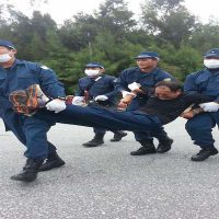 Japanese police carrying away a protestor. Photo: Eliza Egret