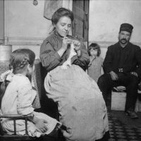 Family sitting in living room (Image by Lewis Wickes Hine)