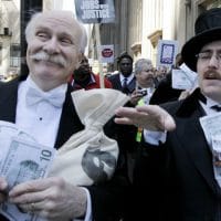 Protesters, dressed as wall street bankers, march from Goldman Sachs’ office to a rally in Federal Plaza demanding Wall Street reform, Wednesday, April 28, 2010, in Chicago. (AP Photo/M. Spencer Green)