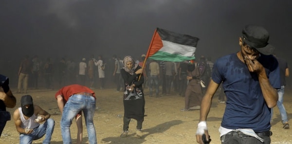 | A Palestinian woman waves the national flag on Nakba day a day after Israeli troops massacred 60 unarmed civilians | MR Online