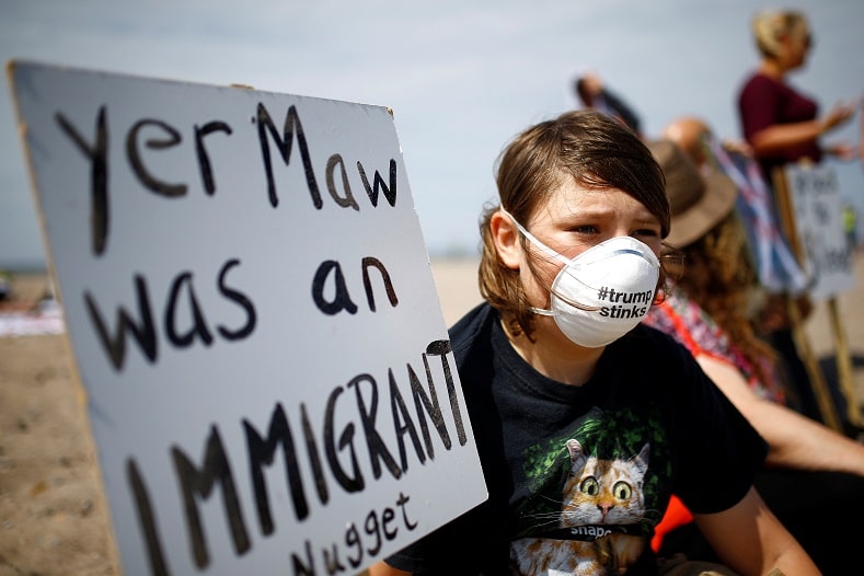 | A demonstrator holds a placard near the golf resort owned by US President Donald Trump during Trumps stay at the resort in Turnberry | MR Online