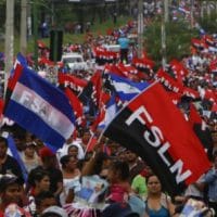 Sandinistas and followers of President Daniel Ortega wave their Sandinista flags in a march for peace, in Managua, Nicaragua, Saturday