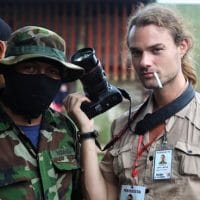 Carl David Goette-Luciak poses with an opposition gunman in the city of Masaya, Nicaragua. Photo | Edge of Adventure