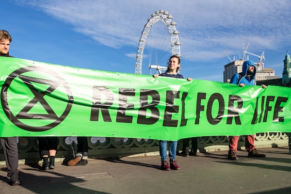 | Extinction Rebellion activists hold a banner reading Rebel for life Photo Credit Thomas Katan | MR Online