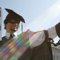 In this 6 October 2011 photo, a protester holds a ball and chain representing his college loan debt during the Occupy DC protests in Washington DC. (AP:Jacquelyn Martin)