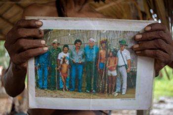 | Tari Uru Eu Wau Wau holds up a photo of the first contact between the tribe and officials from FUNAI Aside from a dwindling number of uncontacted tribes and those living in voluntary isolation many Indigenous groups want development and links to the world But they are pushing for alternative models that preserve the forest Photo Gabriel Uchida | MR Online