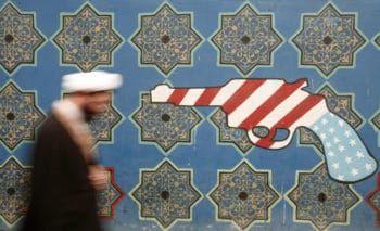 | An Iranian cleric walks past a mural on the wall of the former US embassy Tehran February 2007 Morteza NikoubazlReuters | MR Online