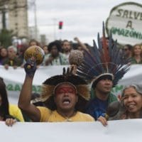 Indigenous people protest in defense of the Amazon while wildfires burn in that region, in Rio de Janeiro, Brazil, Sunday, Aug, 25, 2019. Experts from the country's satellite monitoring agency say most of the fires are set by farmers or ranchers clearing existing farmland, but the same monitoring agency has reported a sharp increase in deforestation this year as well. (AP Photo/Bruna Prado)