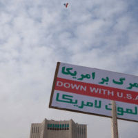 An Iranian woman (not pictured) holds up an anti-U.S. placard during a rally to mark the 35th anniversary of Iran’s Islamic Revolution