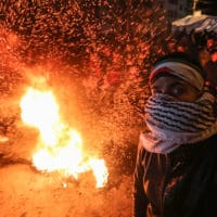 Palestinian demonstrators burn tyres during a protest against US President Donald Trump's Century Deal "expected peace plan" in Khan Yunis in the southern of Gaza Strip January 28, 2020. Donald Trump has launched his ìultimate dealî for Middle East peace, saying his detailed 80-page plan would be a ìrealistic two-state solutionî that had already been agreed to by Israel. Photo by Ashraf Amra