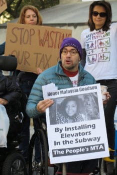 | Sasha Blair Goldensohn co founder of Rise and Resist Elevator Action Group holds up a poster honoring Malaysia Goodson | MR Online