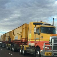 Lone truck on road-train travels down an empty highway