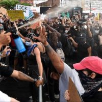 NYPD officers spray Mace into the crowd of protesters gathered at Barclays Center to protest the recent murder of George Floyd on May 29, 2020, in Brooklyn, New York. Photo: Kevin Mazur/Getty Images