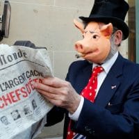 An activist displays a newspaper headlining the ‘Panama Papers’ revelations during a banking managers meeting, in Paris, France. Francois Mori | AP