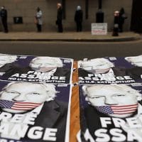 People queue at the entrance of the Old Bailey court in London, Monday, Sept. 21, 2020, as the Julian Assange extradition hearing to the US continues. Frank Augstein | AP