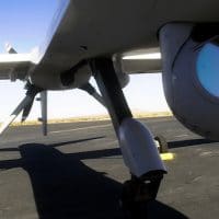 Thomas J. Cassidy, Former President and CEO of General Atomics, is reflected in the camera gimbal on a prototype Predator B, Sept. 6, 2001 in El Mirage, Calif. Doug Benc | AP