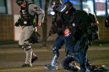 | Portland police officers drag an arrested and injured protester during a march against racial injustice and police brutality in Portland Oregon on September 4 2020 Photo Nathan HowardGetty Images | MR Online