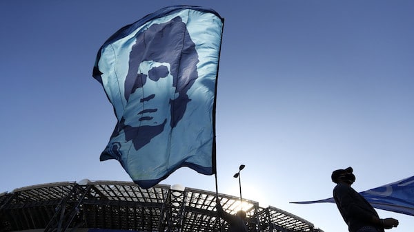 | A person waves a Diego Maradona flag outside the Stadio San Paolo © REUTERSYara Nardi | MR Online