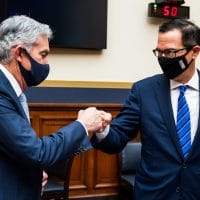 Federal Reserve Chairman Jerome Powell fist bumps Treasury Secretary Steven Mnuchin after a House Financial Services Committee hearing on Capitol Hill in Washington, Dec. 2, 2020. Jim Lo Scalzo | Pool via AP