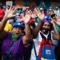 Government supporters chant for parliamentary candidates representing the Great Patriotic Pole party at a closing campaign rally in Caracas, Venezuela, Dec. 3, 2020. Ariana Cubillos | AP