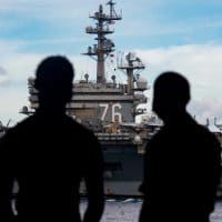 Sailors observe the USS Nimitz and USS Ronald Reagan Carrier Strike Groups steam in formation as the Nimitz Carrier Strike Force (CSF) in the South China Sea. Photo by 3rd Class Dalton Reidhead/Flickr.