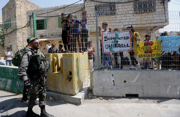 | ISRAELI BORDER POLICEMEN STAND GUARD DURING A DEMONSTRATION ORGANIZED BY YOUNG PALESTINIANS IN HEBRON ON SEPTEMBER 3 2017 AGAINST A RECENT DECISION BY ISRAEL GIVING JEWISH SETTLEMENT ENCLAVES IN HEBRON THE AUTHORITY TO MANAGE THEIR OWN MUNICIPAL AFFAIRS PHOTO WISAM HASHLAMOUNAPA IMAGES | MR Online