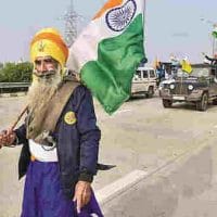 A 'Nihang' holds the Tricolor during farmers' tractor rally as part of their ongoing protest against the new farm laws, at Dankaur in Gautam Buddha Nagar District, Thursday, Jan. 07, 2021. PTI