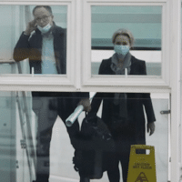 World Health Organisation team members prepare to board a plane, marking the end of their WHO mission in Wuhan, China