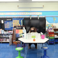 Emma Kash, a teacher at Yung Wing School P.S. 124 wears a mask and teaches remotely from her classroom on Sept. 24, 2020 in New York City. (Michael Loccisano/Getty Images)