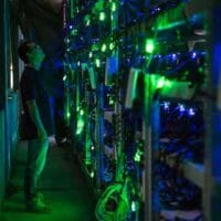 A manager checks equipment at a Bitcoin mine near Kongyu Township, Sichuan province, Aug. 12, 2016. Paul Ratje/The Washington Post//People Visual