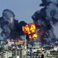 In this July 22, 2014 file photo, smoke and fire from a devastating Israeli airstrike rise over Gaza City during the holy month of Ramadan. Photo by Hatem Moussa.