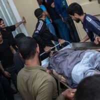 The body of a Palestinian man named Ahmed Al-Shenbari, who was killed during an Israeli raid on Beit Hanoun City, is taken to a mortuary on May 11, 2021 in Gaza. (Photo: Fatima Shbair via Getty Images)