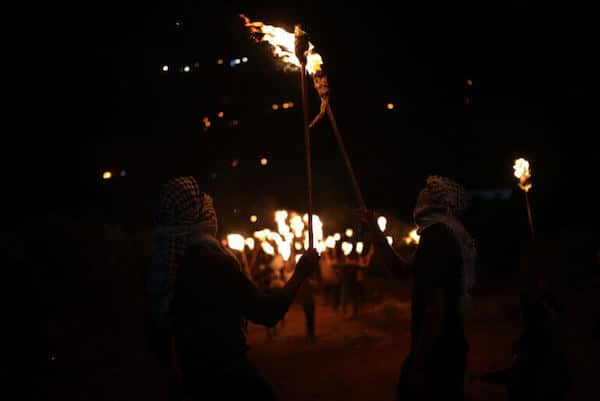 | PALESTINIANS CARRY TORCHES DURING A NIGHT DEMONSTRATION AGAINST THE EXPANSION OF A JEWISH SETTLEMENT ON THE LANDS OF BEITA VILLAGE NEAR THE OCCUPIED WEST BANK CITY OF NABLUS ON JUNE 23 2021 PHOTO BY SHADI JARARAH C APA IMAGES | MR Online