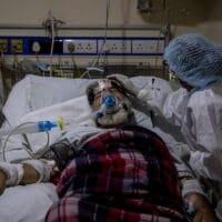 | A medical worker tends to a patient suffering from the coronavirus disease COVID 19 inside the ICU ward at a hospital in New Delhi India April 29 2021 | MR Online