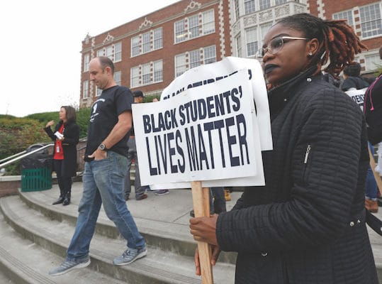 | Felecia Bazie 18 a senior and president of Associated Student Government at Garfield High School holds signs following a Black Lives Matter rally Oct 19 2016 at the school in Seattle Teachers students and parents across Seattle public schools wore Black Lives Matter shirts to promote racial equity in schools AP PhotoTed S Warren | MR Online