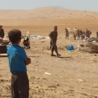 Palestinian boy looks on as Israeli soldiers destroy and confiscate residents’ belongings in Humsa