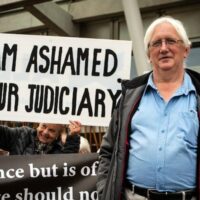 Craig Murray, poses with supporters outside the Scottish Parliament. (Photo: The Scotsman)