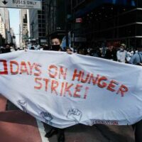 Protesters holding a sign.