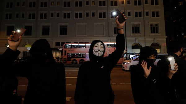 | People raise their mobile phone lights as they form a human chain on New Years eve in Hong Kong Dec 31 2019 | MR Online