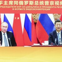 Chinese President Xi Jinping (R) met with Russian President Vladimir Putin via video link on December 15, 2001