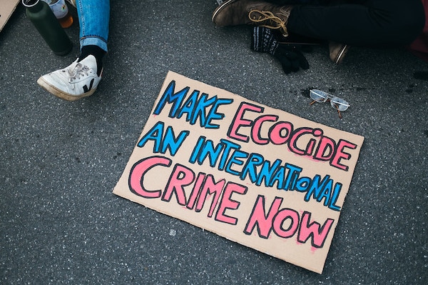 | Make Ecocide An International Crime Now sign on the tarmac at a rally against climate change | MR Online