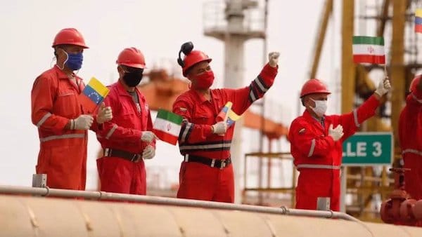 | Workers of the state oil company Pdvsa holding Iranian and Venezuelan flags greet during the arrival of the Iranian tanker ship Fortune at El Palito refinery in Puerto Cabello Venezuela May 25 2020 Photo by Reuters | MR Online