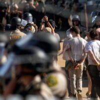 Activists are escorted out of an Enbridge Line 3 pump station after being arrested near Park Rapids, Minn., on June 7, 2021.