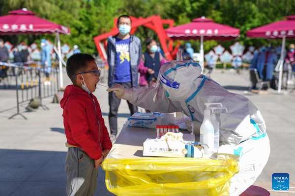 | A medical worker takes a swab sample from a resident for nucleic acid testing in Daxing District Beijing | MR Online