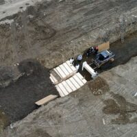 Prisoners in hazmat suits were spotted digging mass graves on Hart Island in New York City to bury victims of the coronavirus pandemic.