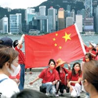 THE FUTURE IS BRIGHT THE FUTURE IS CHINA: Young people celebrate, under the Chinese flag, the 25th anniversary of Hong Kong’s reunification with China